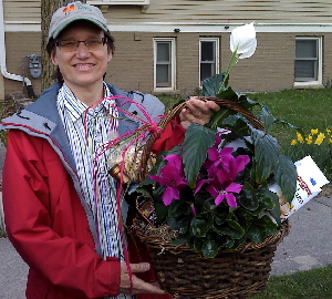 Ann in front of our home accepting homecoming gift from Church friends.